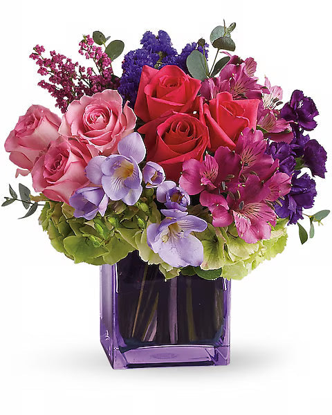 Colorful flower bouquet in a purple vase 
