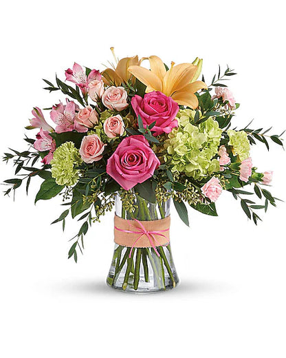 Bouquet of flowers in a clear vase on a white background