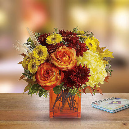 Elegant flowers in glass vase for home decor on wooden surface